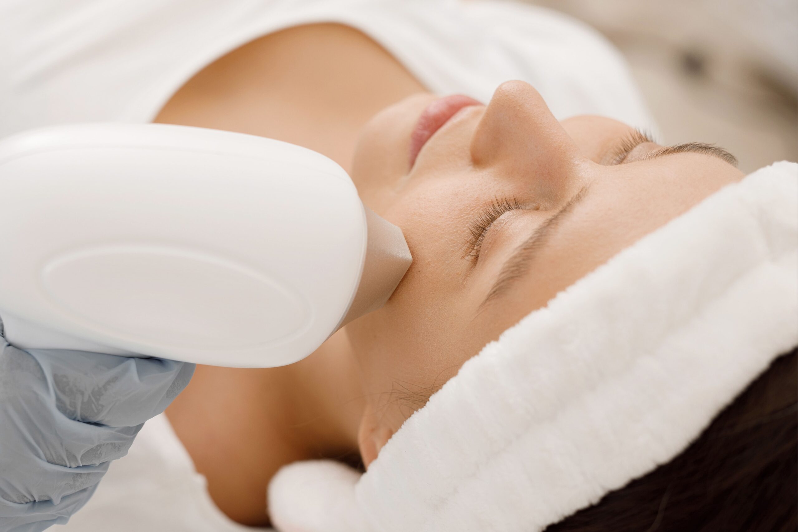 a woman receiving a face laser treatment